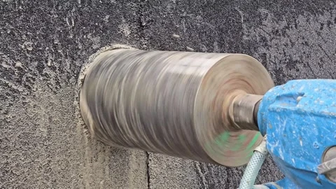 A blue and silver tool is being used to remove a hole in a wall Stock Footage 304780266