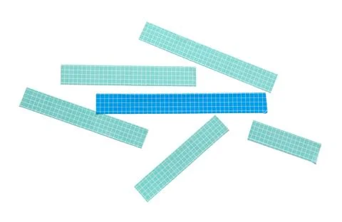 Blue and teal grid patterned rectangular paper strips scattered on white back Stock Photos