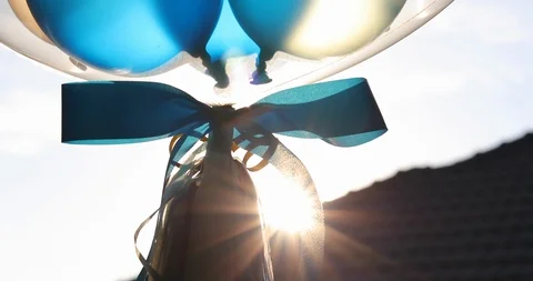 Blue and white balloon floating in sky with sun light Stock Footage 86807175