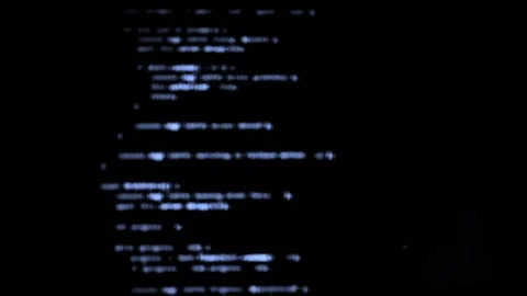 Blue and white blurred code appears on dark computer screen background. Def.. Stock Footage 333143478