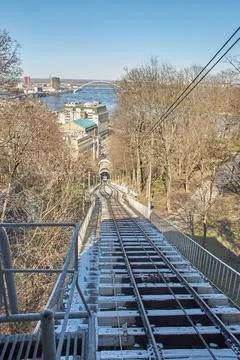A blue and white cable funicular rises Stock Photos