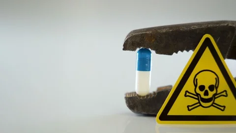 A blue and white capsule on the jaw of the pliers Stock Footage 129452857