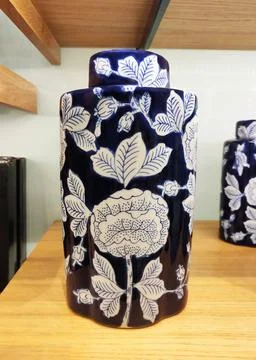 Blue and white ceramic covered vase decorated with white floral painting Stock Photos