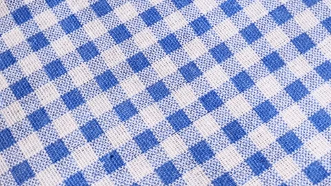 Blue-and-white checkered fabric, rotation in circle. cotton fabric in a cage Stock Footage 281069875