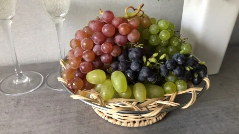 Blue and white grape clusters in the basket on the table Stock Footage 123163455