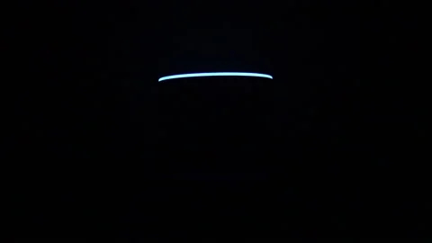 Blue and white led light of a smart speaker assistent in a dark background Stock Footage 166718192