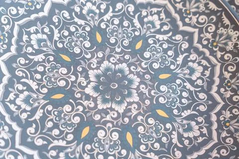 A blue and white patterned plate with a flower design Stock Photos