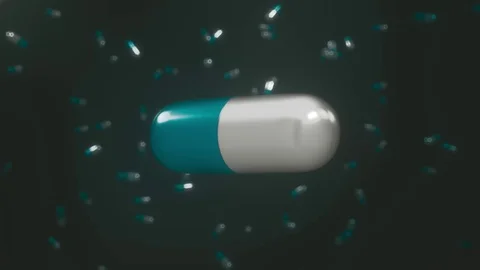 Blue and White Pill Floating on a Black Background 库存影片 72420056