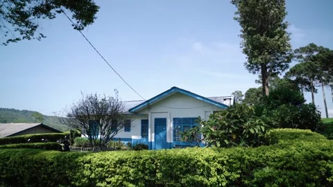 Blue and white tea picker houses with a natural atmosphere during the day Stock Footage 292039302