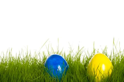 Blue and yellow easter egg in grass Stock Photos