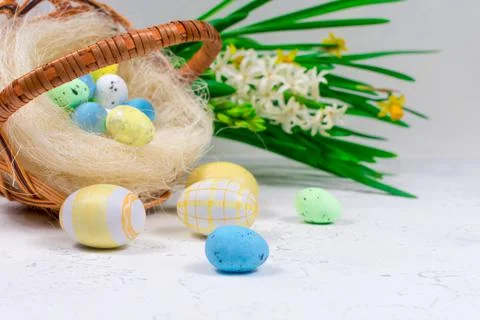 Blue and yellow Easter eggs on a white concrete table against the background of Stock Photos