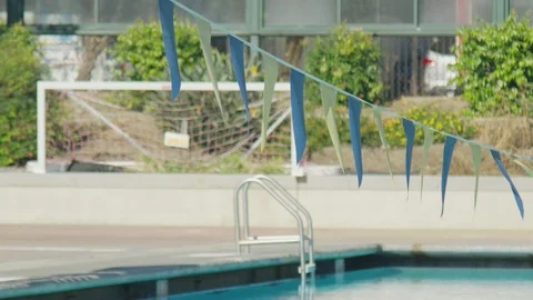 Blue And Yellow Flags Hanging Over Swimming Pool 4 Stock Footage 100542981