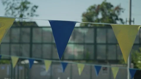 Blue And Yellow Flags Hanging Over Swimming Pool Stock Footage 100542987