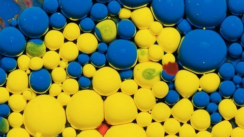 Blue and yellow inks react to form a beautiful structure of paint bubbles. Stock Footage 121222854