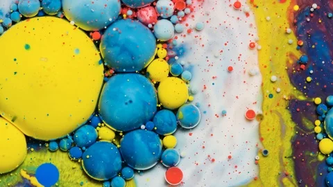 Blue and yellow inks react to form a beautiful structure of paint bubbles. Stock Footage 121223154