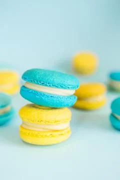 Blue and yellow macaroons on a solid blue background Stock Photos