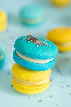 Blue and yellow macaroons on a solid blue background Stock Photos