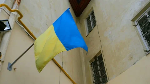 Blue and yellow Ukrainian flag flutters on the wall. Stock Footage 101383634