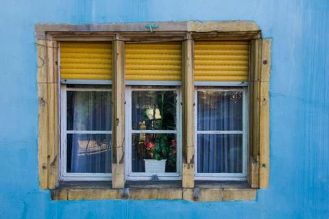 Blue and yellow window frame in the city of Colmar in the Alsace in France Stock Photos