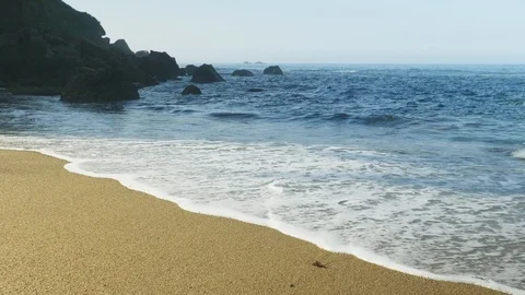 Blue Atlantic Ocean waves at the wild rocky beach Stock Footage 95558574