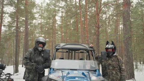 Blue ATV in snowy forest. Preparing for rugged trail through snowy pine woods Stock Footage 332051736