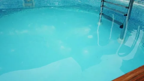 Blue backdrop of a small swimming pool with ladder 動画素材 131235110
