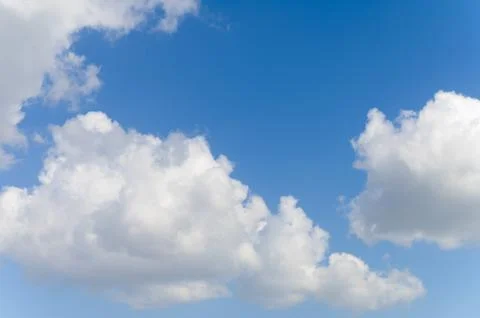 Blue background and huge clouds fluttering in the sky Stock Photos