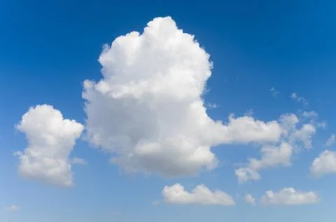 Blue background and huge clouds fluttering in the sky Stock Photos
