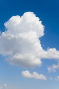 Blue background and huge clouds fluttering in the sky Stock Photos