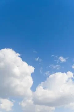 Blue background and huge clouds fluttering in the sky Stock Photos