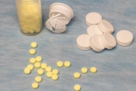 On a blue background are small yellow tablets, and large white ones. there is Stock Photos