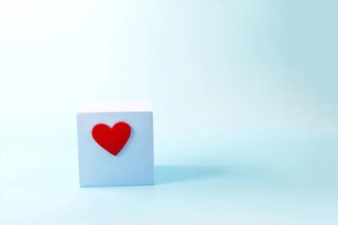 A blue background with a blue cube with a red copy space Stock Photos