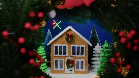 On a blue background a brown house surrounded by many fir trees Stock Footage 311856074