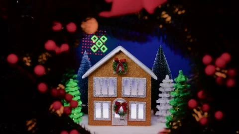 On a blue background a brown house surrounded by multi-colored Christmas trees Stock Footage 311856096