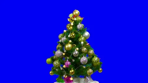 On a blue background Christmas tree decorated with a blinking garland and bells Stock Footage 201002468
