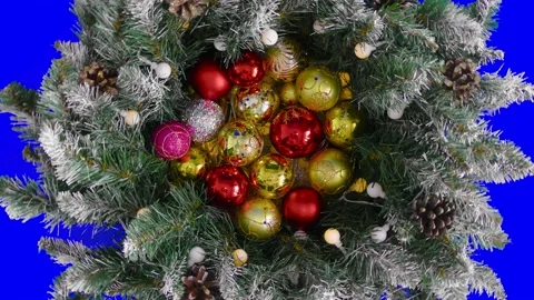 On a blue background chroma key among Christmas tree branches New Year's balls Stock Footage 194675844