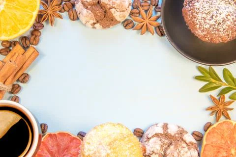 On a blue background decomposed biscuits with cupcakes cup of coffee sliced o Stock Photos