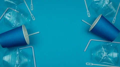 Blue background with falling plastic cups on both sides Stock Footage 117723170