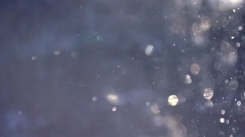 A blue background of falling snow in the rays of the sun Stock Footage 60140537