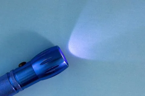 Blue Background with Flashlight On. Turned on Flashlight on a Blue Backgrou.. Stock Photos
