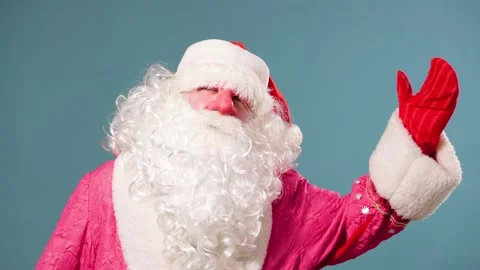 Blue background looking at camera Santa Claus chic white beard is standing and Stock Footage 211681824