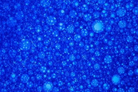 A blue background with many small blue circles Stock Photos