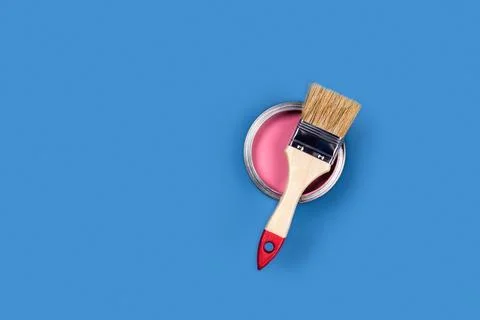 Blue background with paint jar and brush. Stock Photos