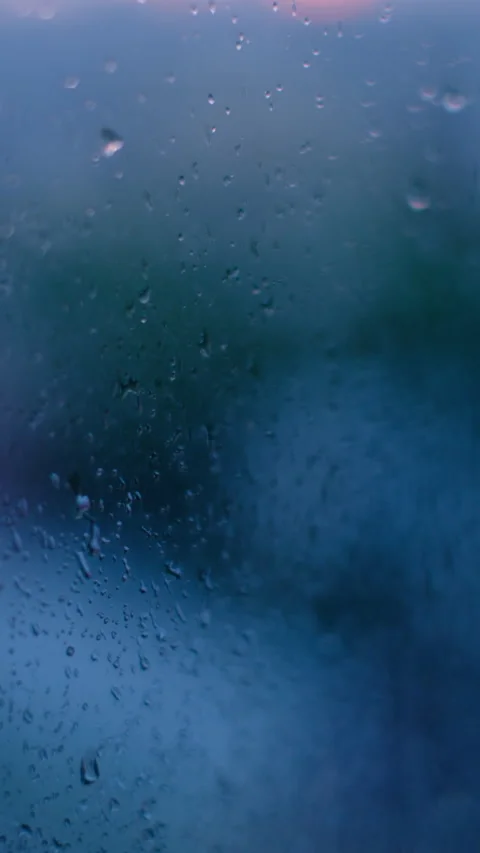 Blue background with rain droplets outside the glass window Stock Footage 282988292