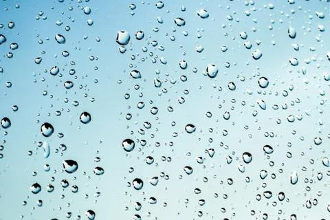 Blue background of raindrops falling Stock Photos