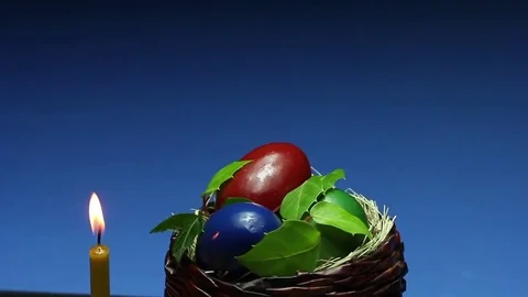 On a blue background revolves wicker basket with Easter eggs 動画素材 73015470