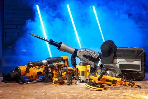 On a blue background, a set of electric tools in one place: an angle grinder, a Stock Photos