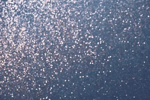Blue background of silver glitter lights. Winter Christmas blurred abstraction Stock Photos