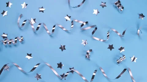 Blue background with a silver serpentine and stars. concept of celebrating a Stock Footage 197849640