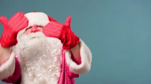 Blue background studio shot dance expressive Santa Claus in anticipation of Stock Footage 211683514